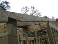 Rafters are birds-mouth-cut to seat on the headers of the outside wall (left foreground) and the inside wall (right) and also cut to fit the roof ridge beam (far right).